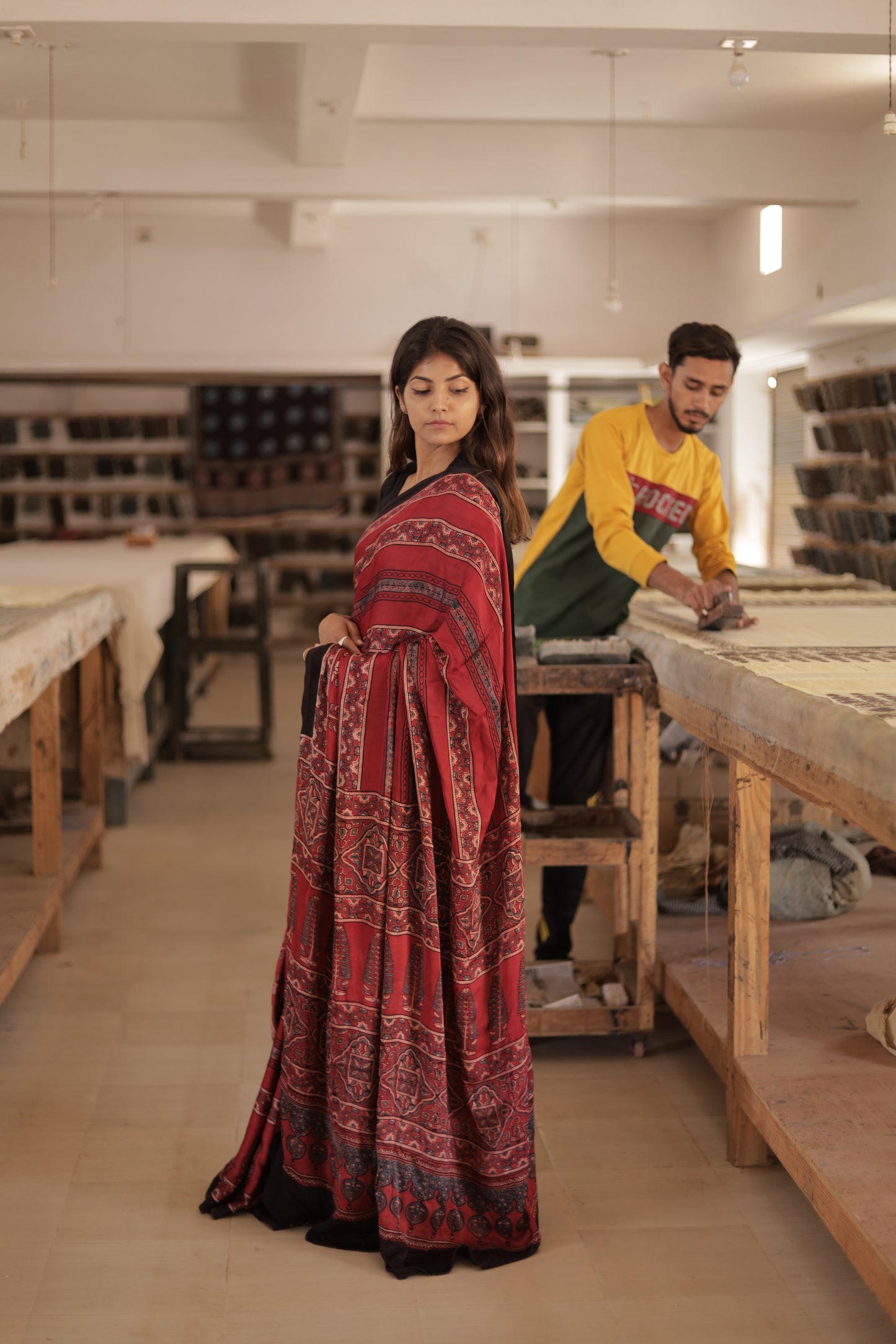 Traditional deep garnet Ajrakh modal silk saree with rich artisanal prints and a soft flowing texture