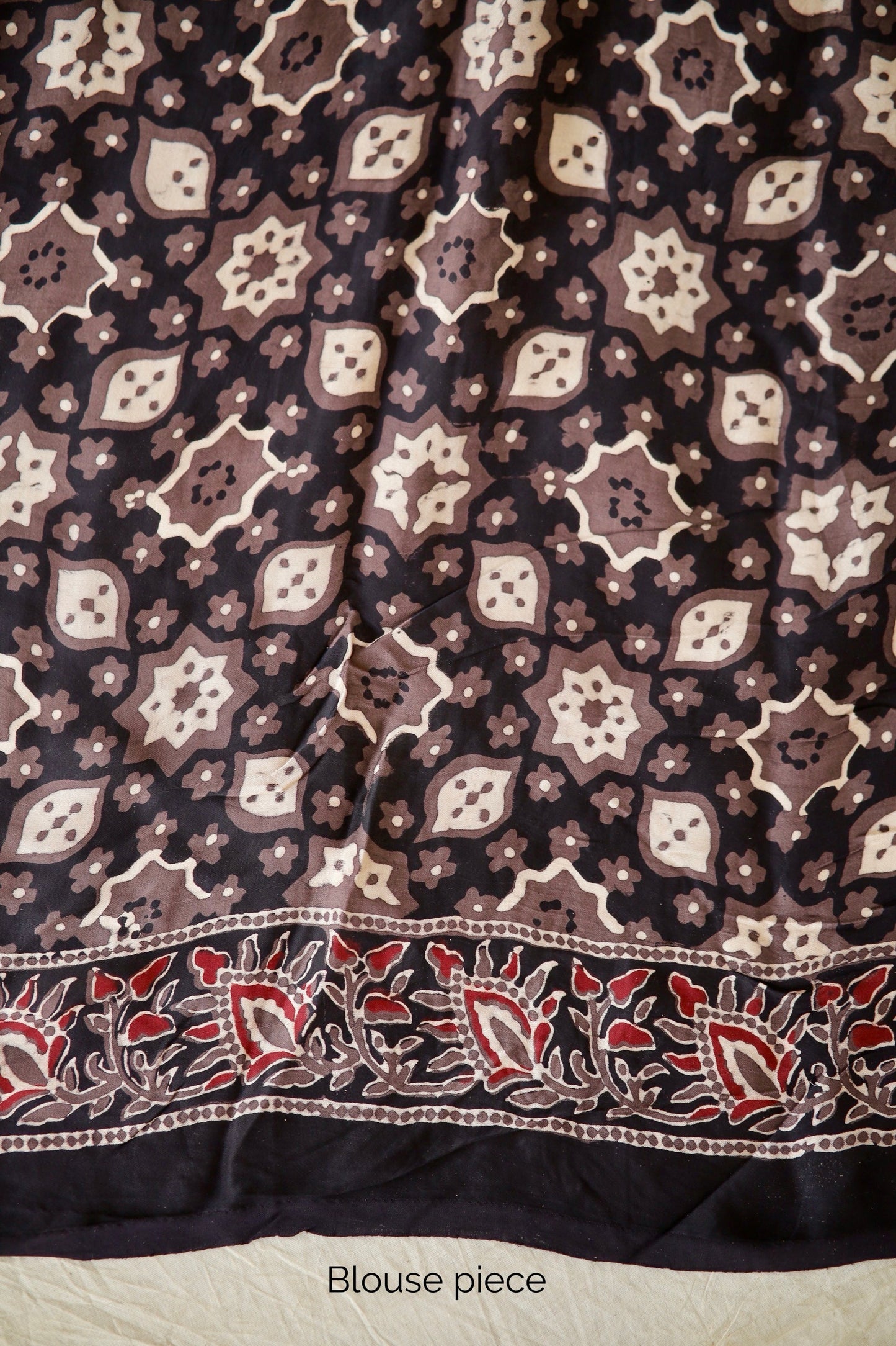 Traditional dusty rose Ajrakh printed modal silk saree crafted by skilled artisans with refined detailing
