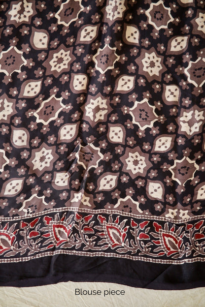 Traditional dusty rose Ajrakh printed modal silk saree crafted by skilled artisans with refined detailing