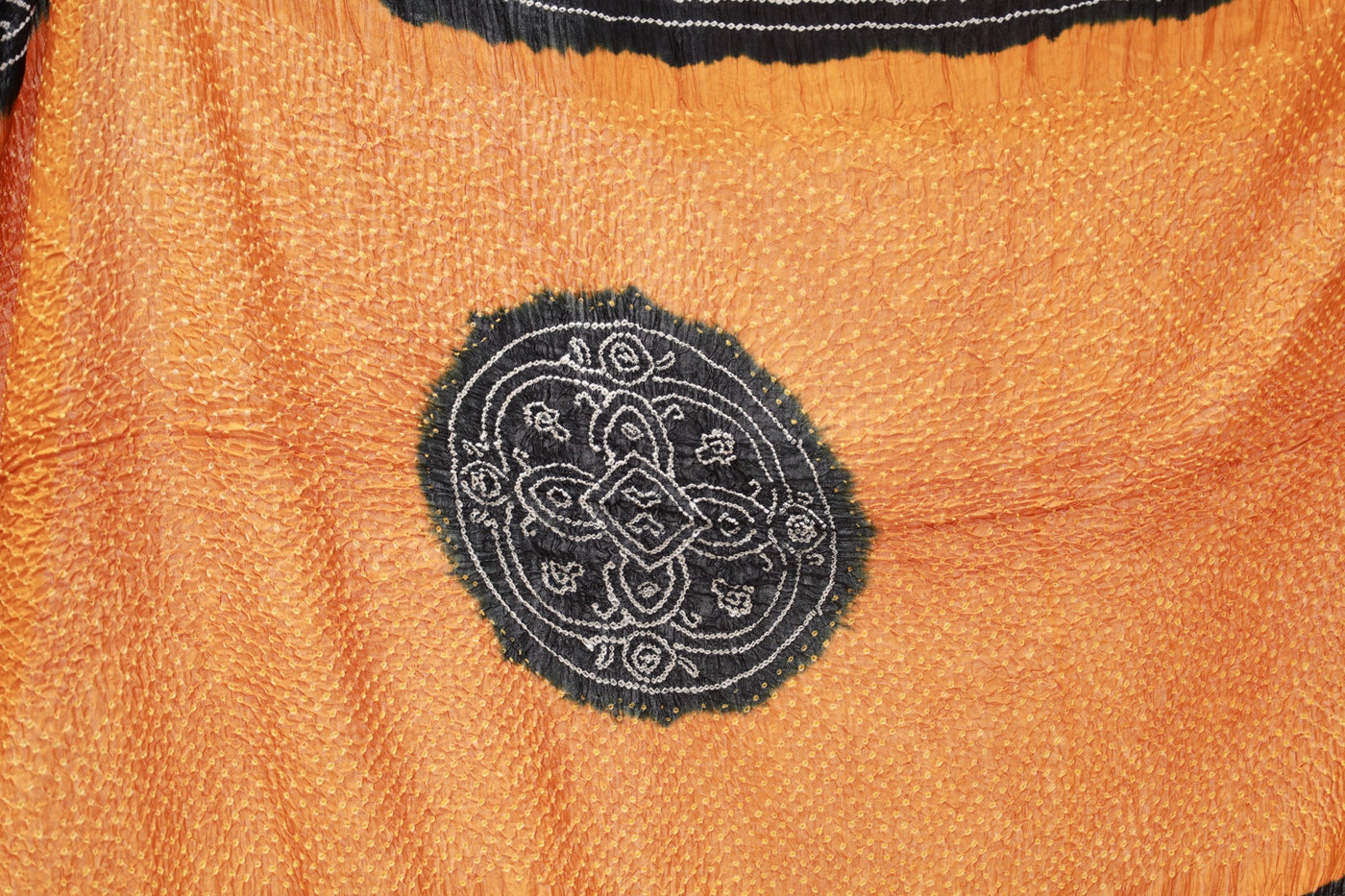 Premium ember Bandhani silk saree highlighting fine artisan craftsmanship and festive elegance