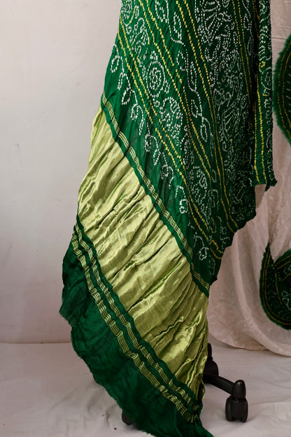 Handcrafted emerald Gajji silk saree showcasing authentic Bandhani artistry with rich zari detailing