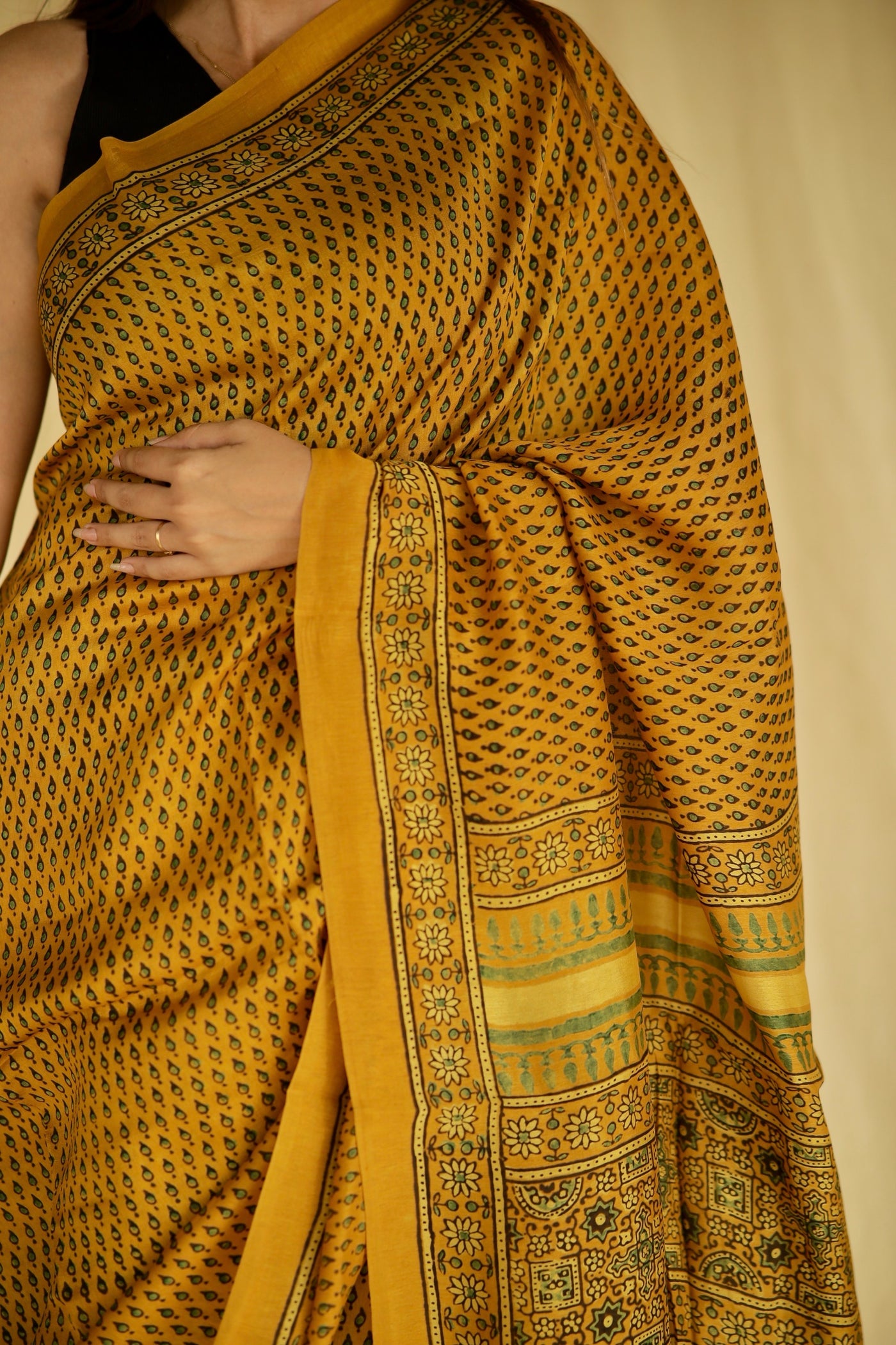 Traditional golden mustard Ajrakh printed Chanderi silk saree crafted by artisans with refined craftsmanship