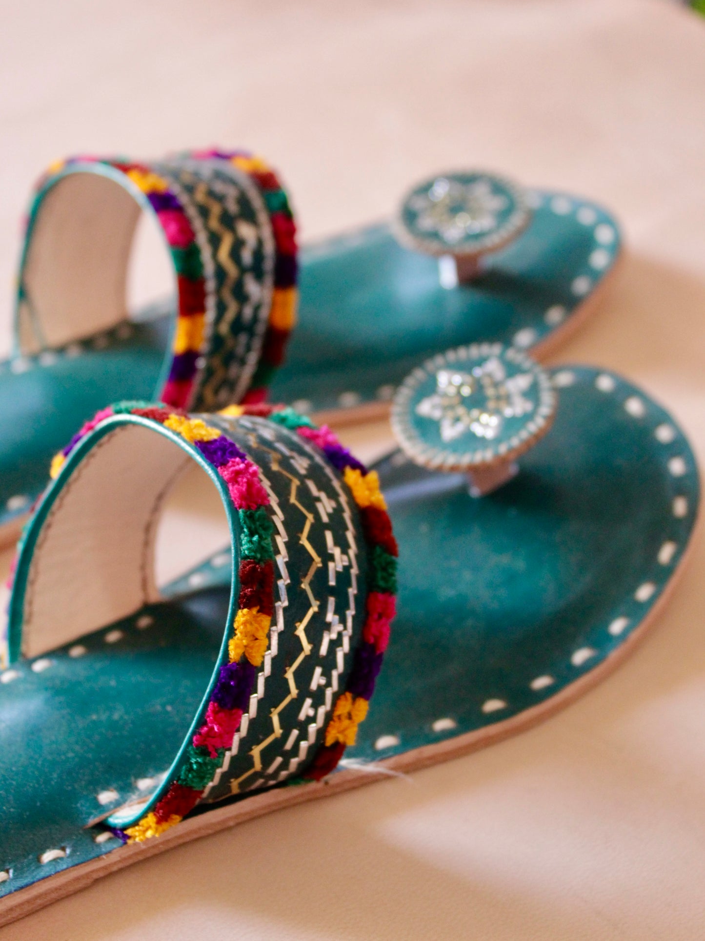 Green handstitched leather flats showcasing traditional craftsmanship and comfortable design