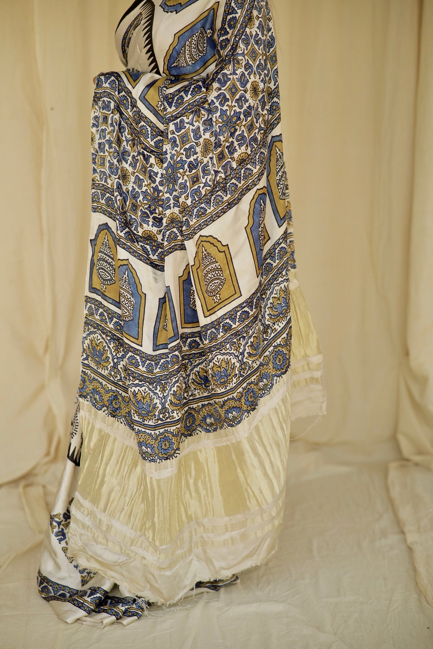 Traditional ivory white Ajrakh printed modal silk saree crafted by artisans with refined craftsmanship