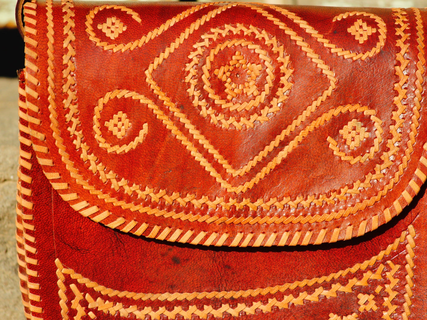 Leather bag featuring intricate thread work on premium handcrafted leather