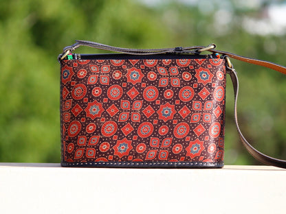 Handcrafted leather bag featuring traditional Kutchi embroidered motifs and fine detailing