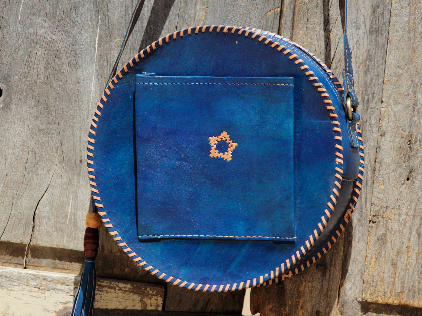Artisan-made leather bag showcasing colorful thread embroidery and traditional craftsmanship