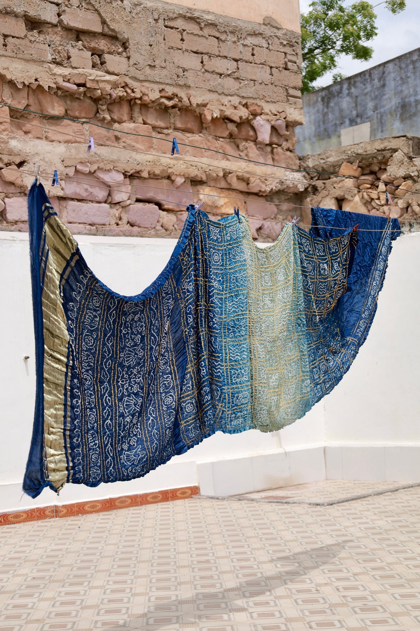 Premium midnight blue Bandhani silk saree highlighting fine artisan craftsmanship and festive elegance