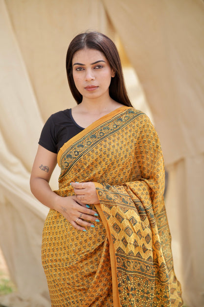 Traditional mustard yellow Ajrakh printed Chanderi silk saree crafted by skilled artisans with refined detailing