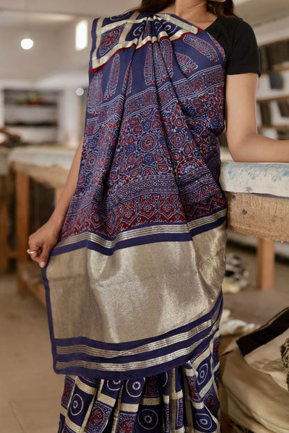 Traditional navy blue Gharchola Ajrakh modal silk saree with rich patterns and a soft flowing texture