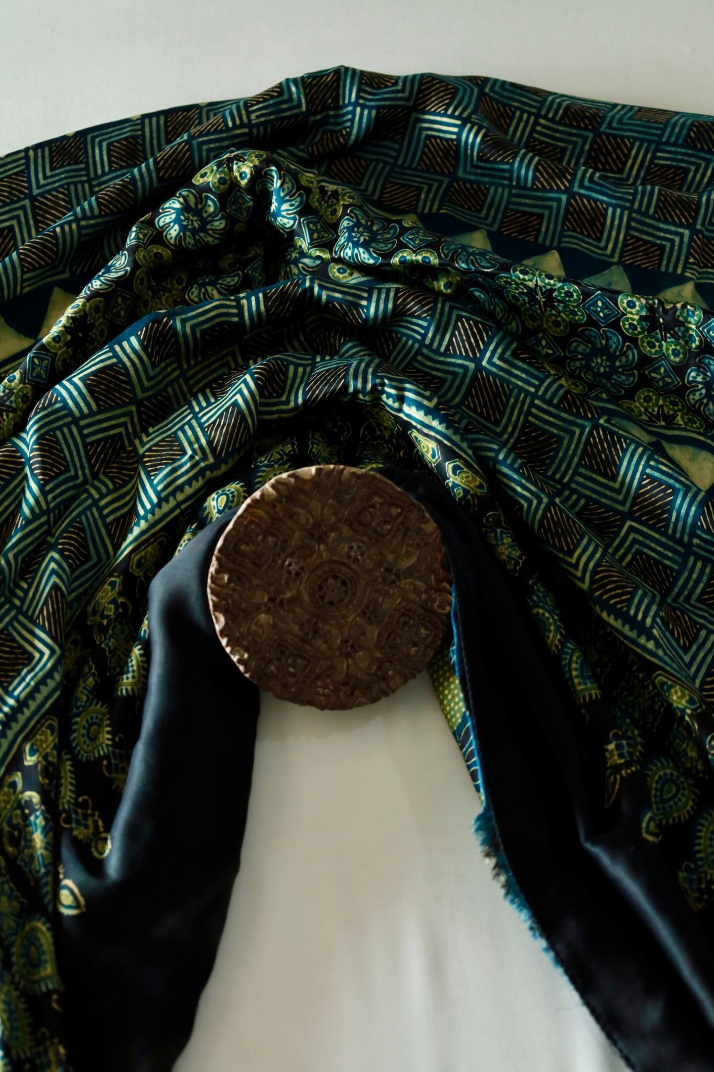 Traditional navy teal Ajrakh modal silk saree with rich artisanal prints and a soft flowing texture