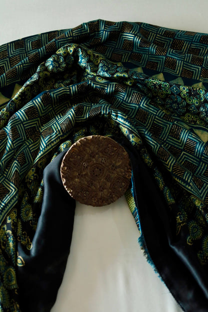Traditional navy teal Ajrakh modal silk saree with rich artisanal prints and a soft flowing texture