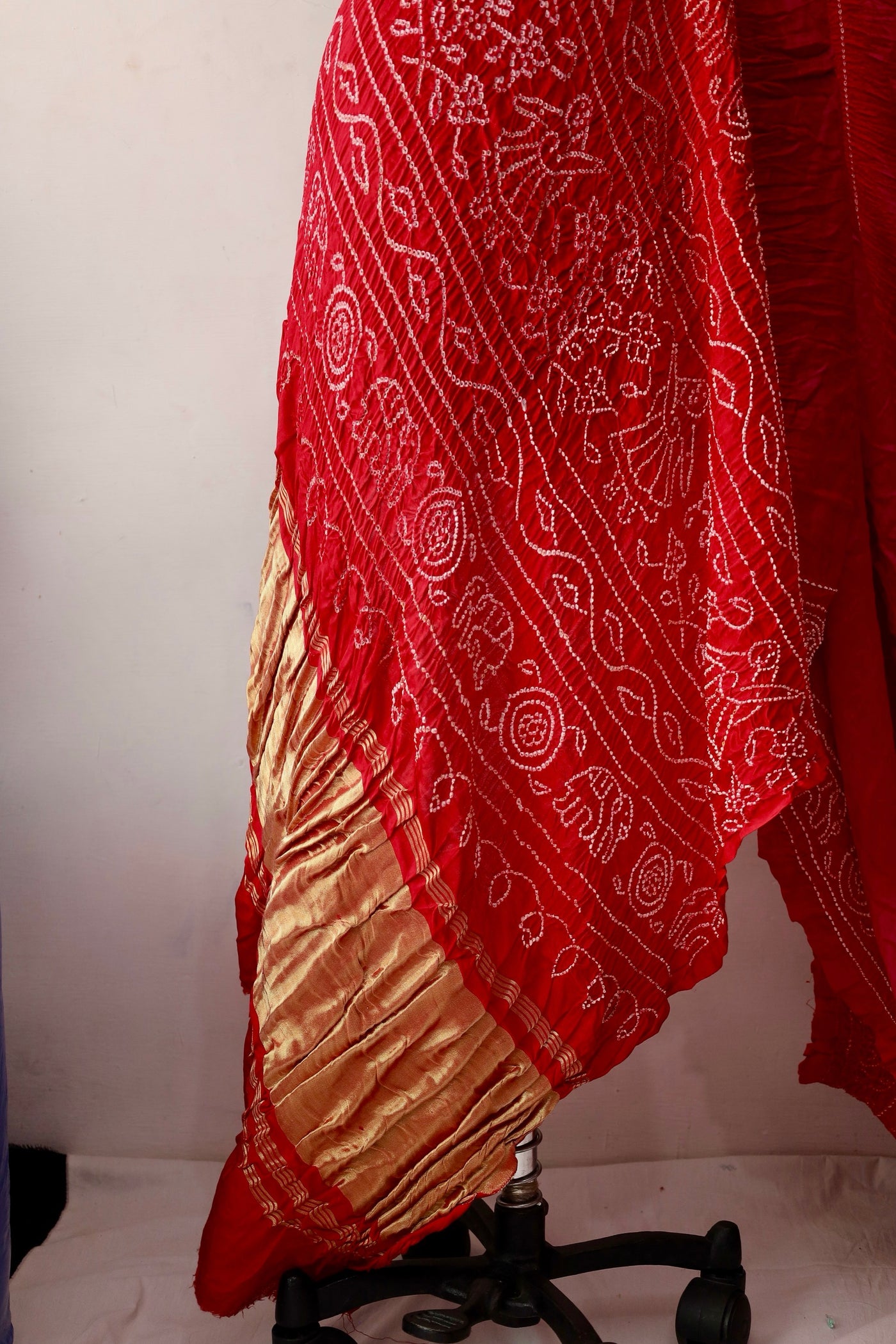 Handcrafted ruby Gajji silk saree showcasing authentic Bandhani artistry with rich zari detailing