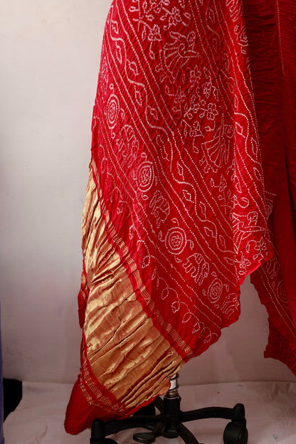 Handcrafted ruby Gajji silk saree showcasing authentic Bandhani artistry with rich zari detailing