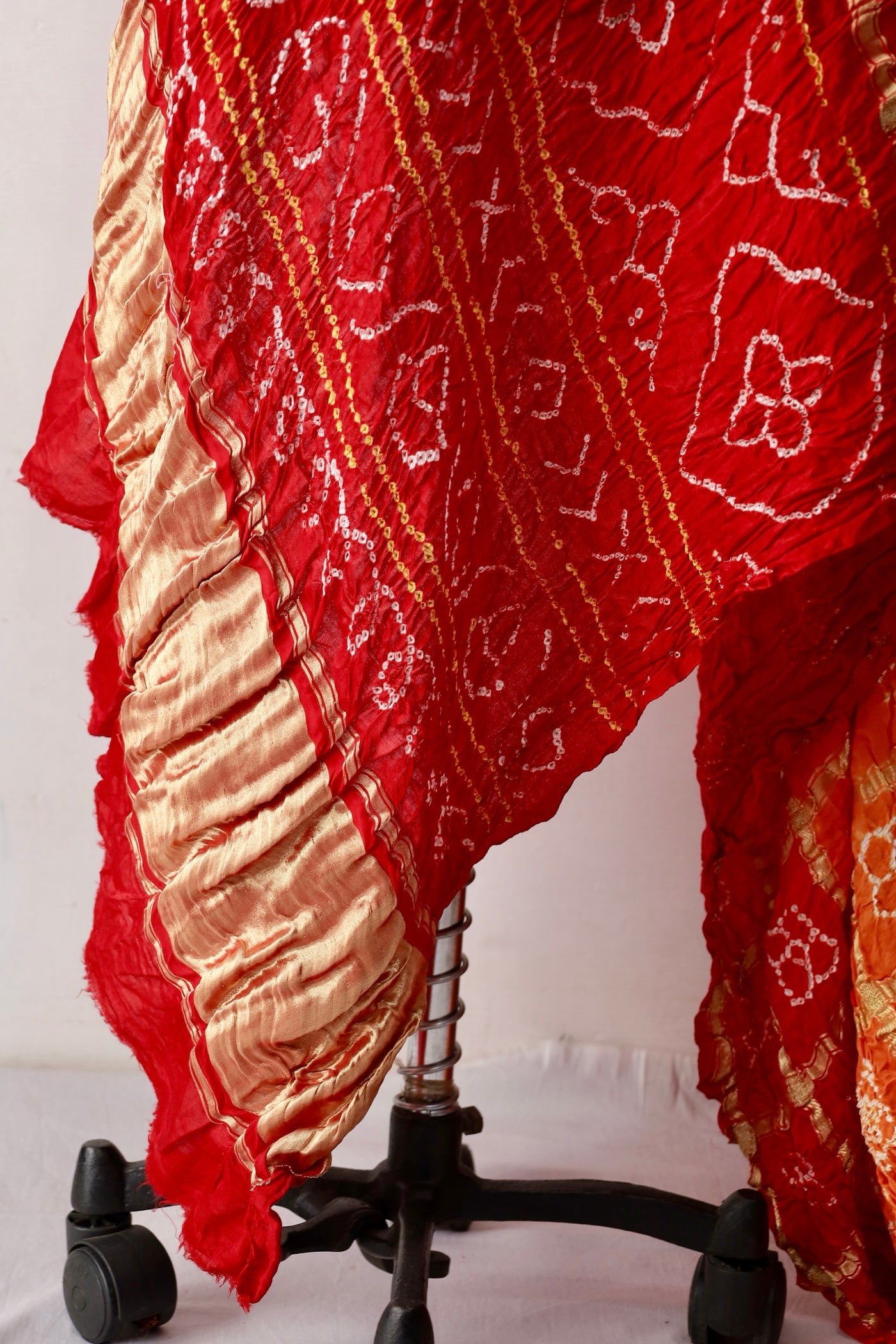Premium sunset Bandhani Gharchola Gajji silk saree highlighting intricate artisan craftsmanship
