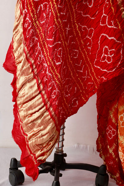 Premium sunset Bandhani Gharchola Gajji silk saree highlighting intricate artisan craftsmanship