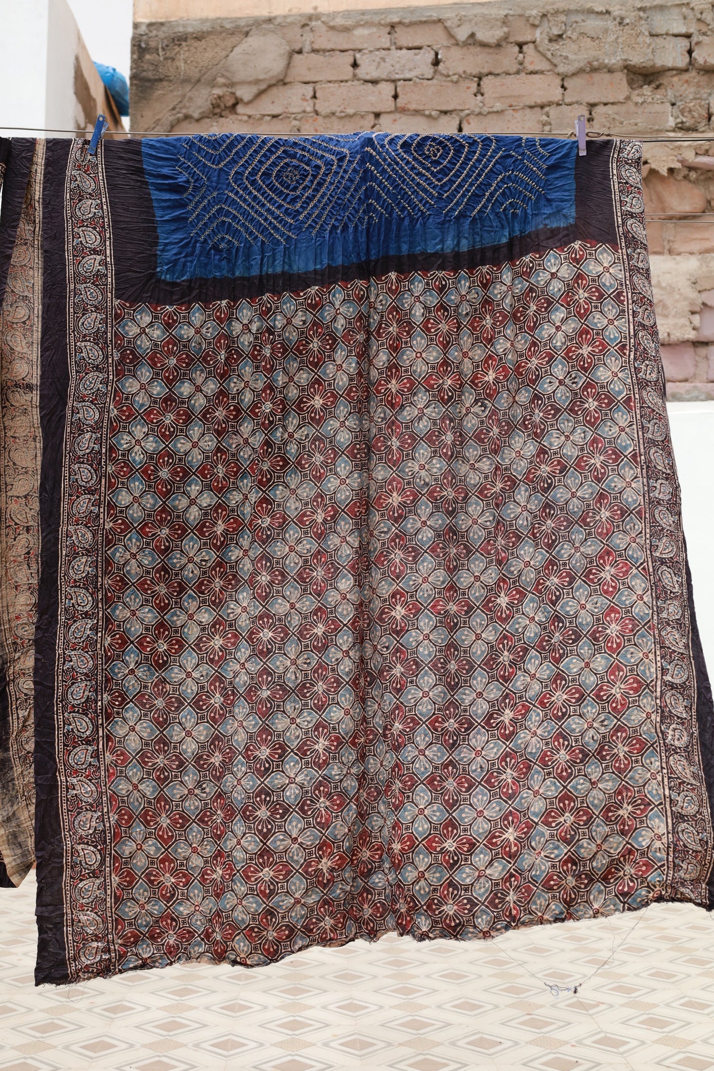 Premium teal silk saree blending traditional Ajrakh printing with Bandhani artistry