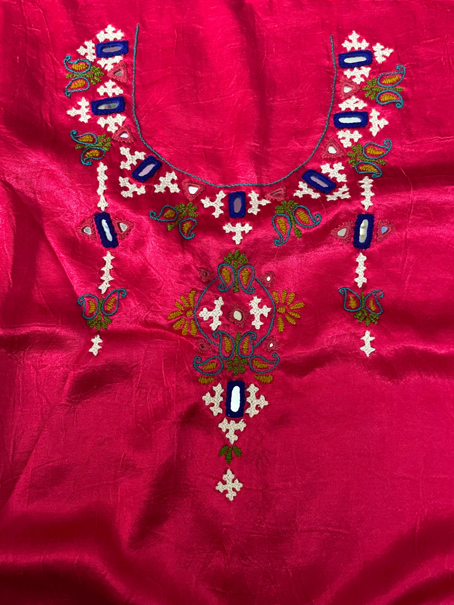 Elegant vibrant pink dress material adorned with beautiful Ahir embroidery motifs