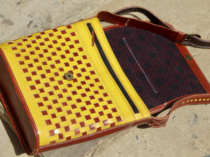 Premium leather bag combining durable leather construction with decorative zari work