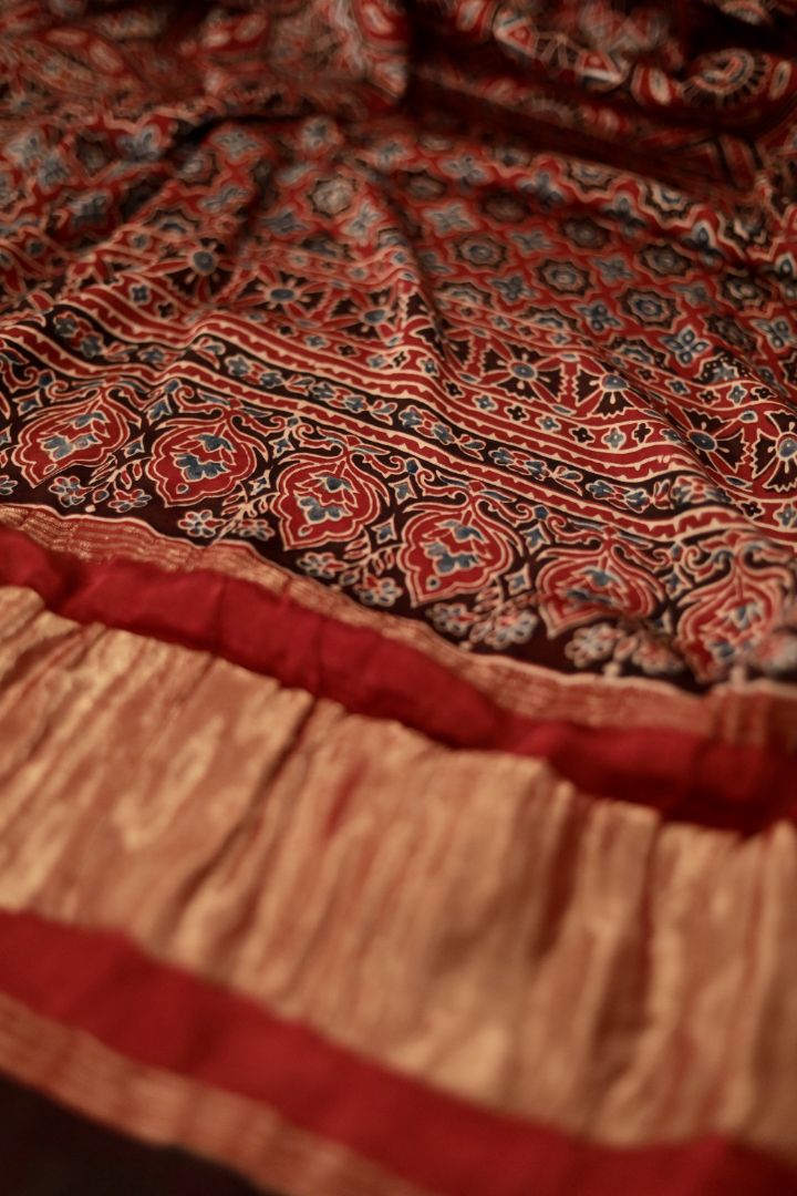 Handcrafted burnt rust Ajrakh dupatta made from premium modal silk with traditional Lagdi Patta detailing