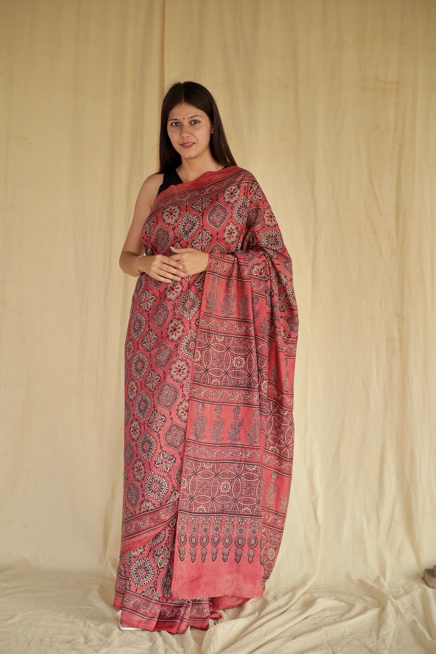 Raspberry pink Ajrakh Chanderi silk saree featuring intricate hand block printed motifs and a graceful drape