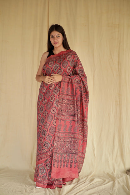 Raspberry pink Ajrakh Chanderi silk saree featuring intricate hand block printed motifs and a graceful drape