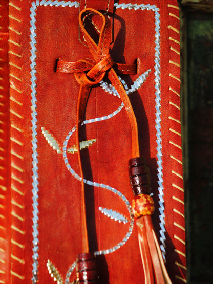 Premium leather potli bag combining durable leather construction with heritage zari artistry