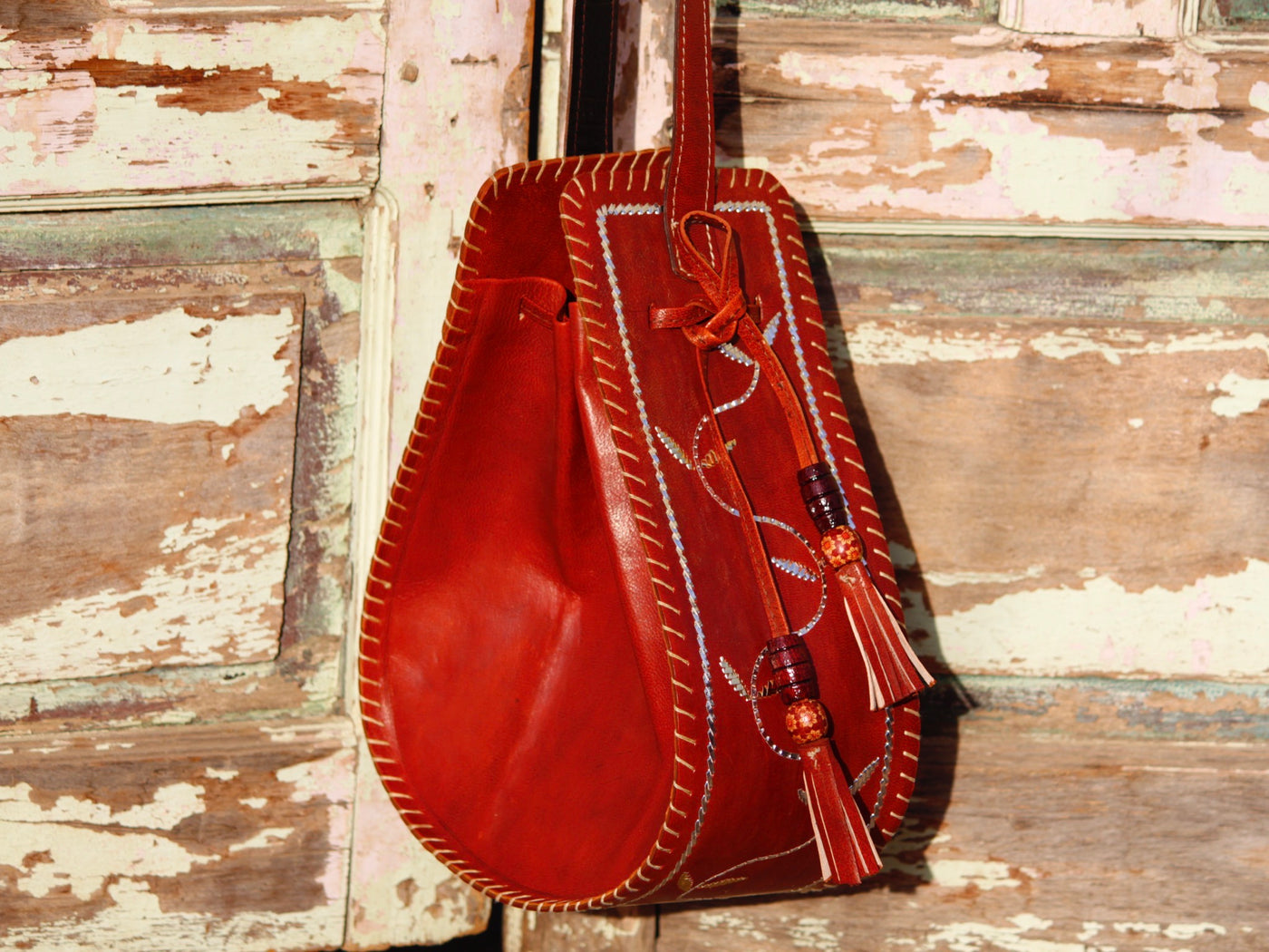 Artisan-made leather potli bag featuring traditional metallic zari embellishments
