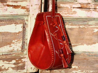 Artisan-made leather potli bag featuring traditional metallic zari embellishments
