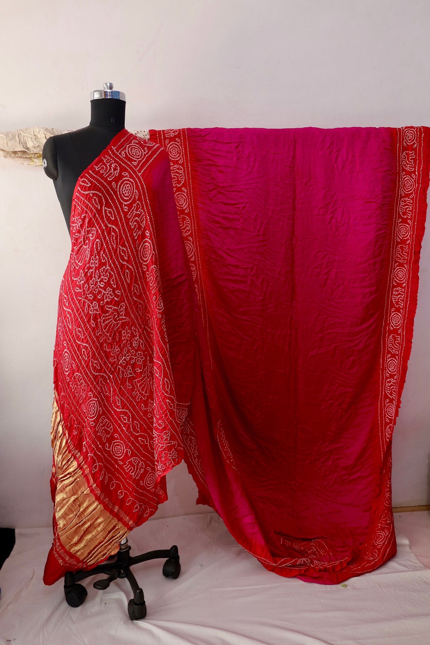 Ruby Bandhani Gajji silk saree featuring intricate tie-dye patterns and an elegant zari pallu