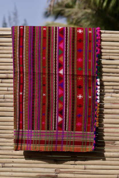 Ruby red handwoven woolen shawl featuring a rich jewel-toned hue and artisan craftsmanship