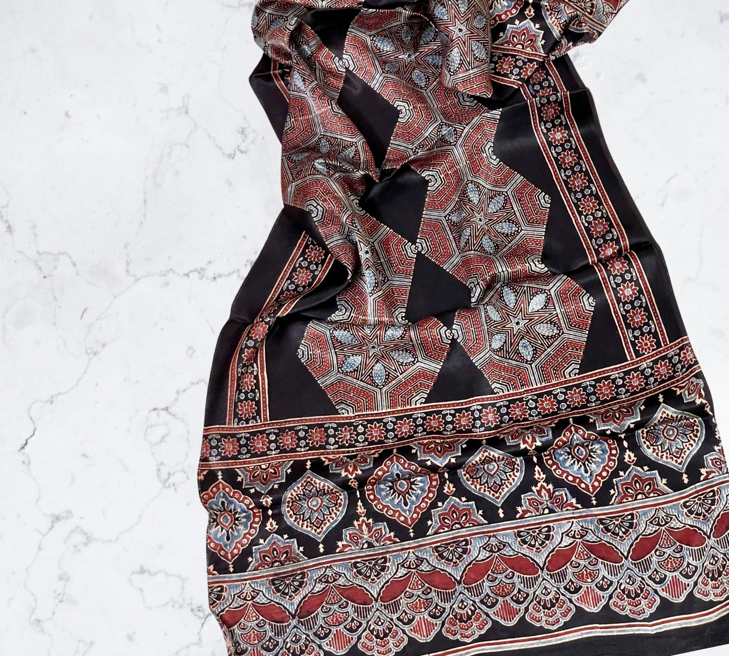 Rust black Ajrakh modal silk stole featuring intricate hand block printed motifs and elegant drape