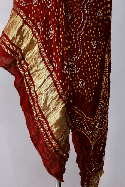 Luxurious rust red Bandhani dupatta crafted in soft and lustrous Gajji silk