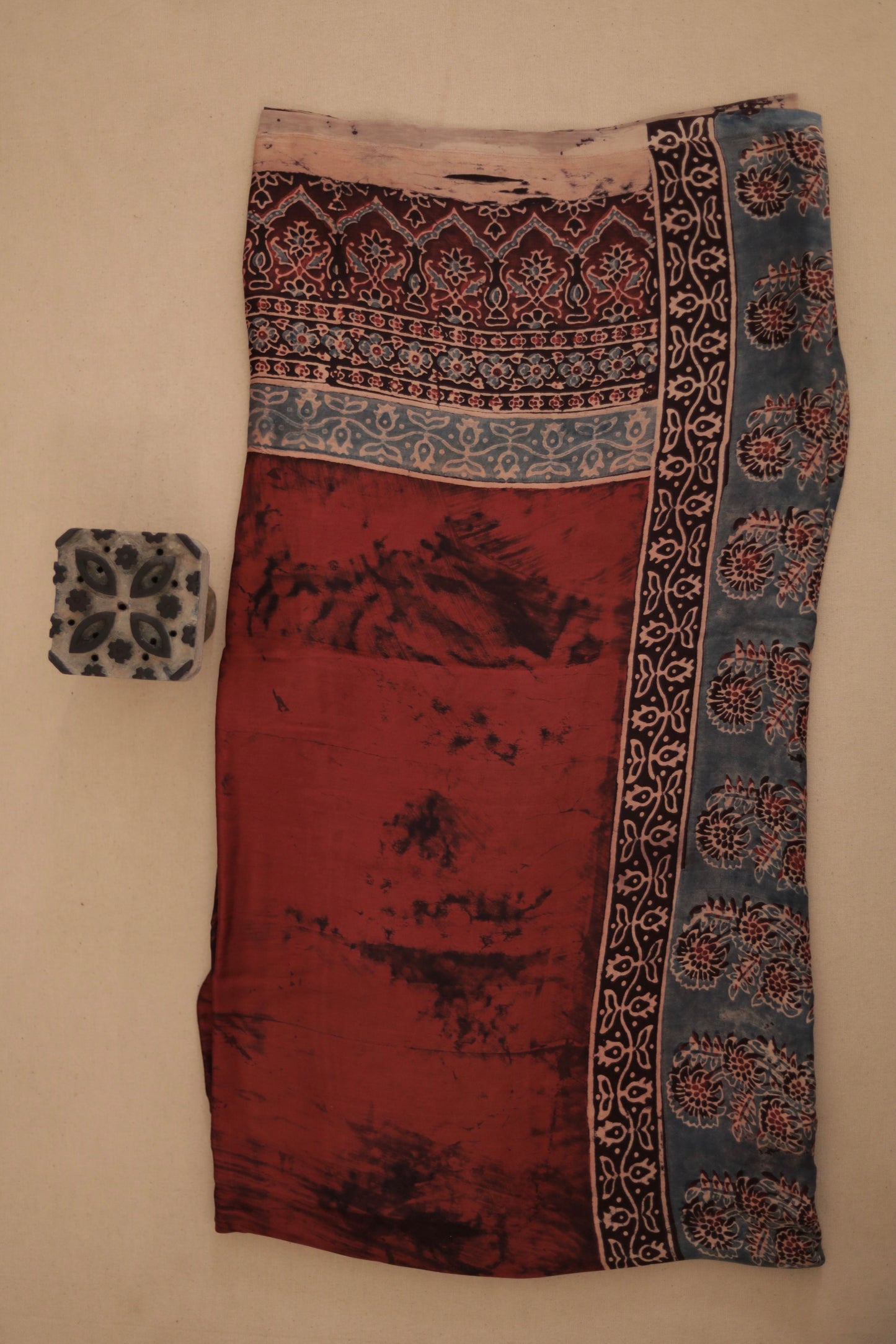 Rustic maroon Ajrakh modal silk dupatta featuring intricate hand block printed motifs and elegant drape