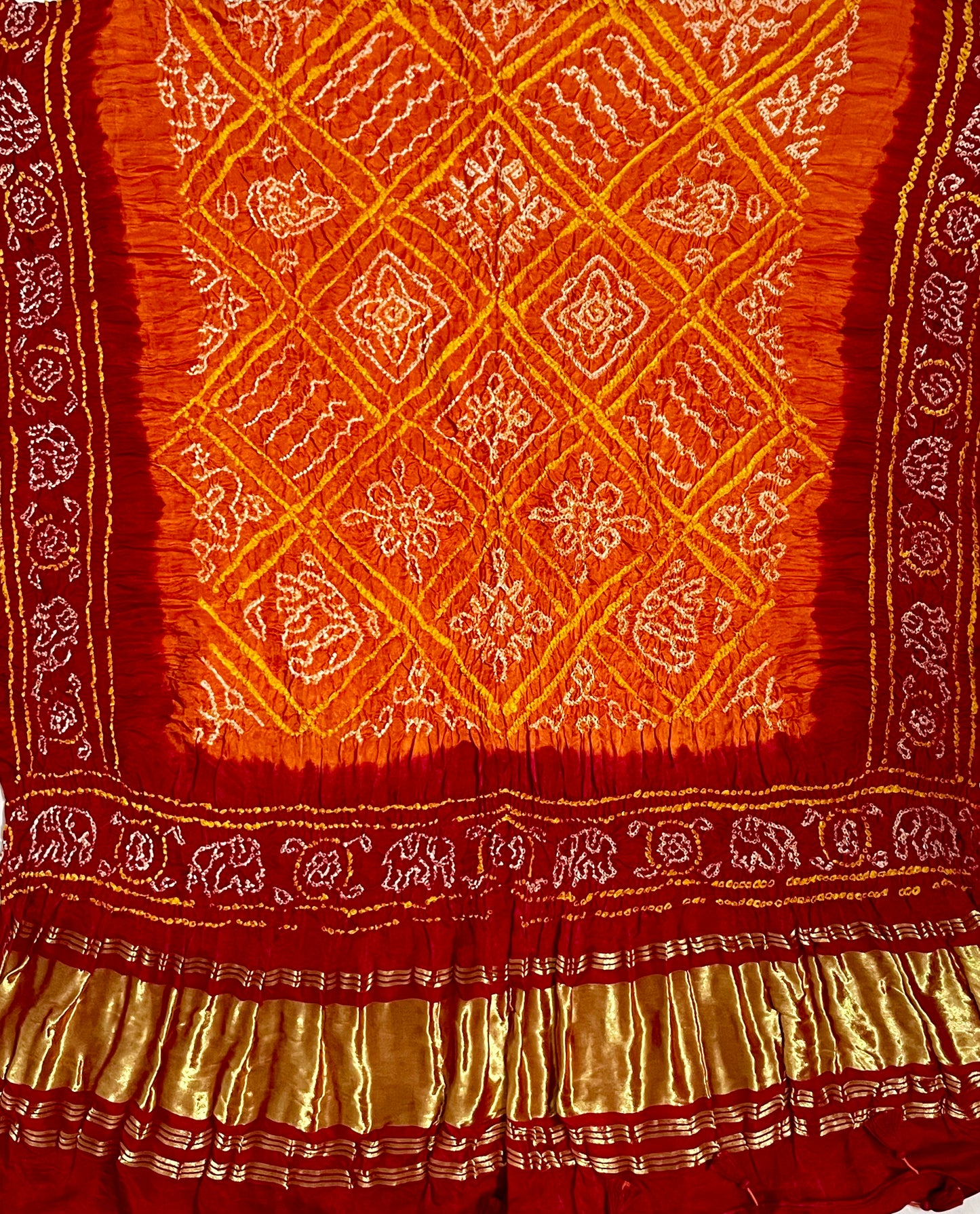 Saffron orange and red Bandhani Gajji silk dupatta featuring traditional tie-dye craftsmanship and elegant drape