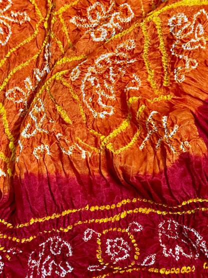 Traditional saffron orange and red Bandhani Gajji silk dupatta with intricate artisanal patterns