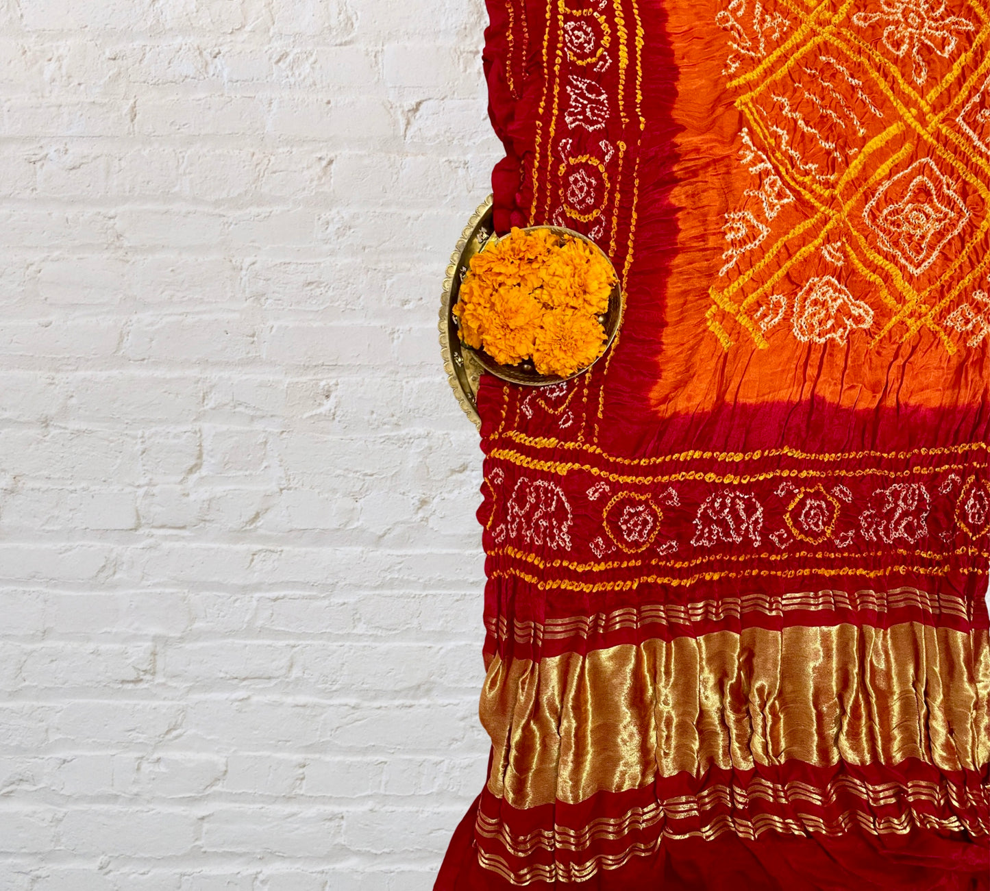 Handcrafted saffron orange and red Bandhani dupatta made from premium Gajji silk fabric
