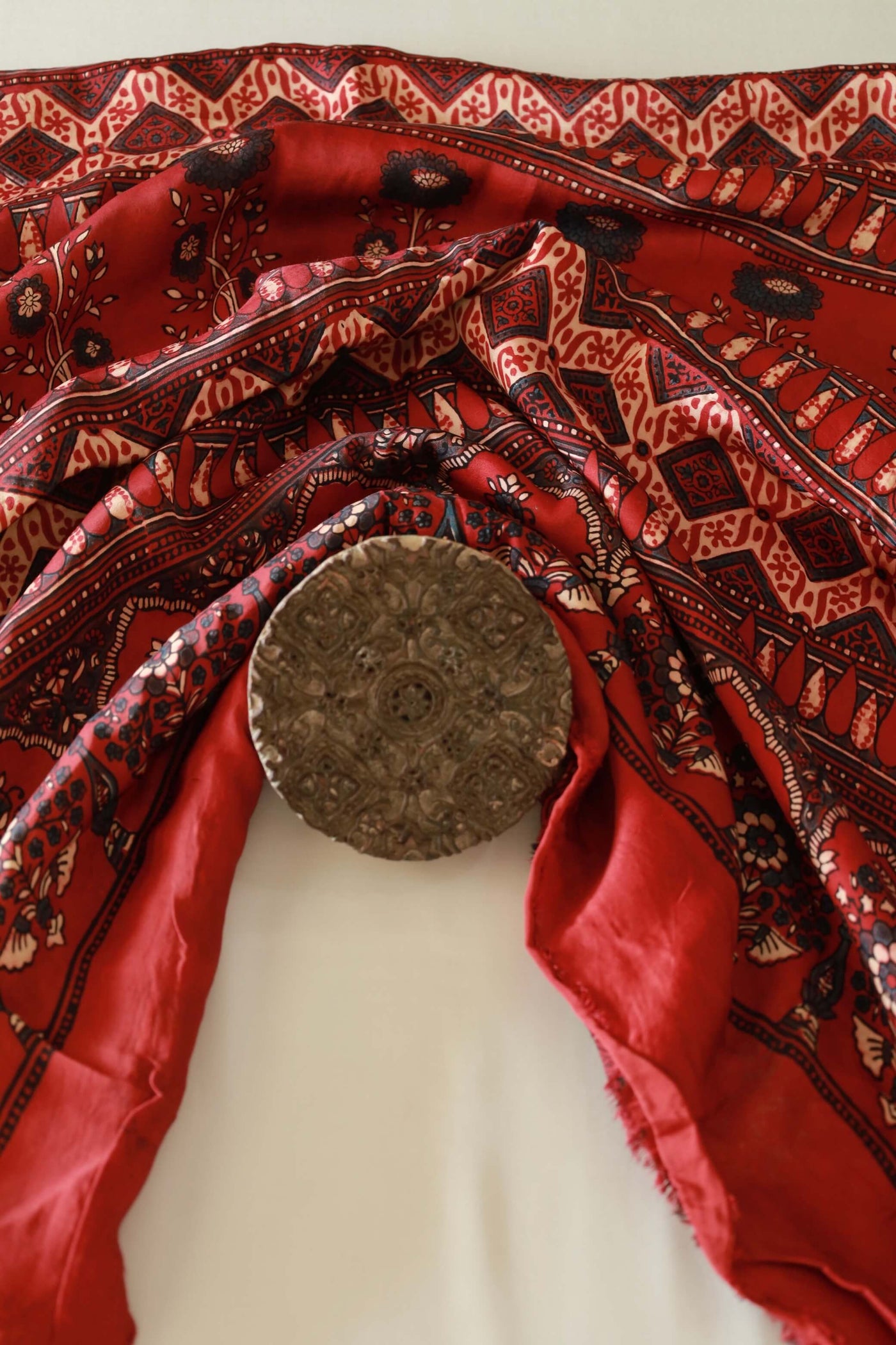 Scarlet red Ajrakh modal silk saree featuring intricate hand block printed motifs and graceful drape