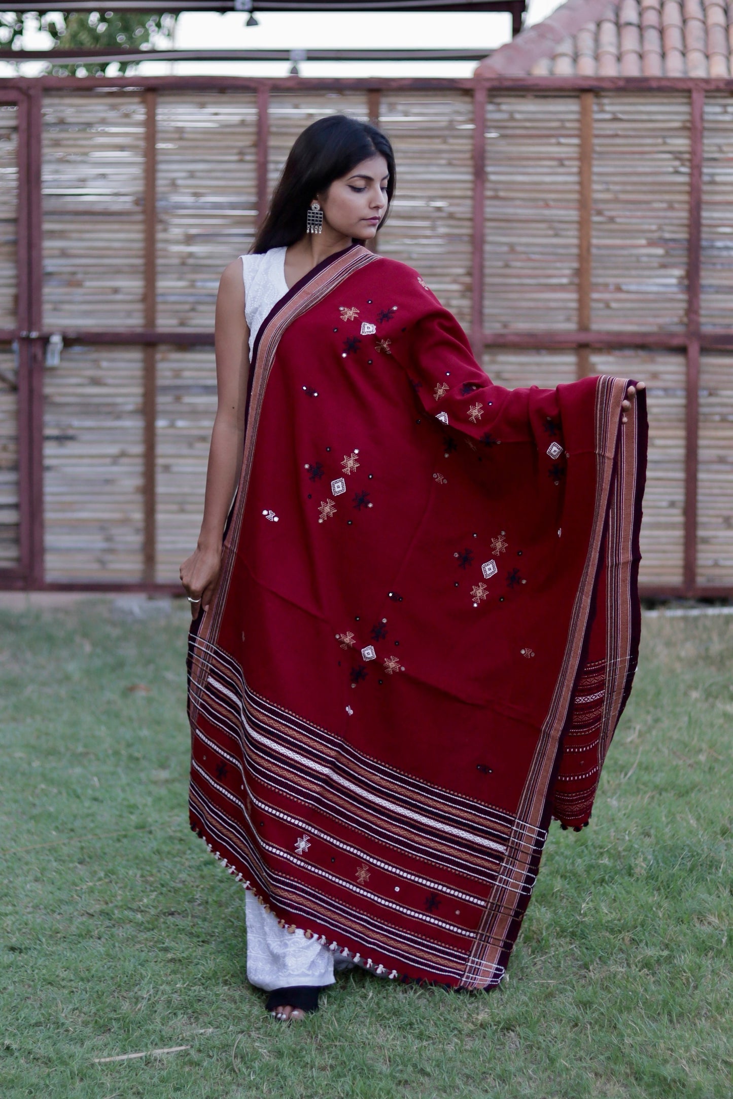 Scarlet red handwoven woolen shawl featuring a vibrant hue and exceptional artisan craftsmanship