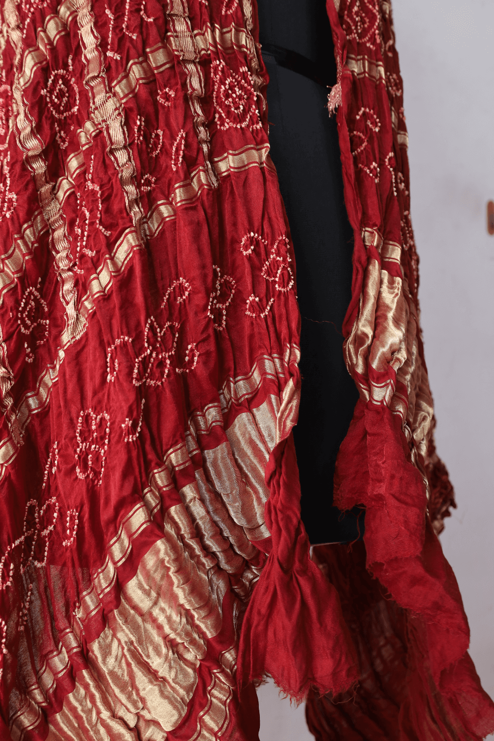 Handcrafted scarlet red Gharchola dupatta adorned with authentic Bandhani artistry