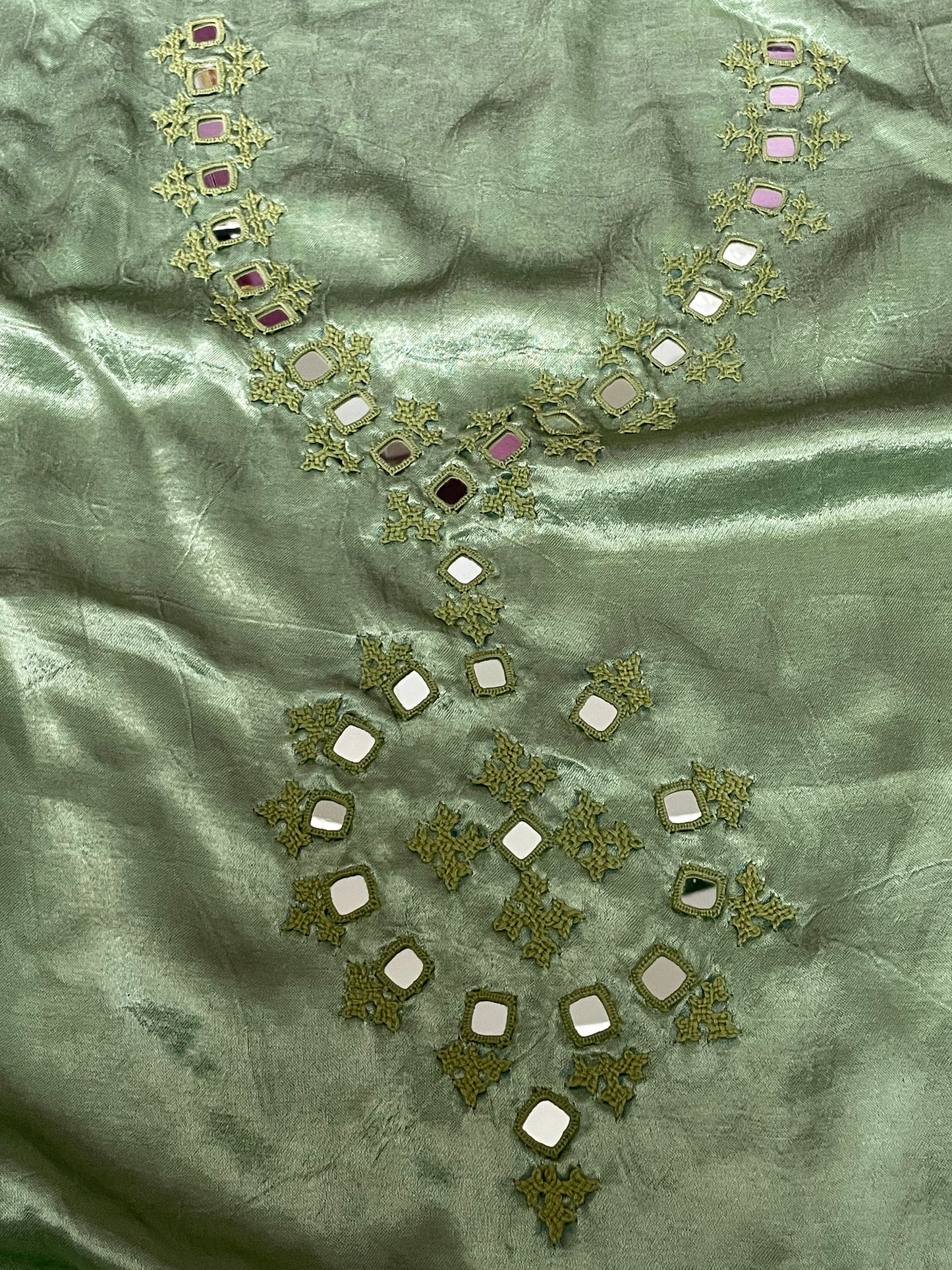 Soft green mirror work dress material showcasing intricate handcrafted embellishments