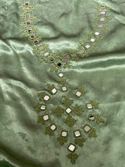 Soft green mirror work dress material showcasing intricate handcrafted embellishments
