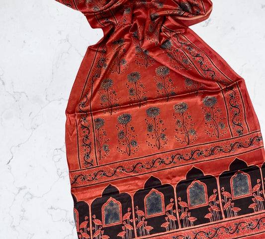 Terracotta red Ajrakh Mashru silk stole featuring intricate block printed motifs and elegant drape
