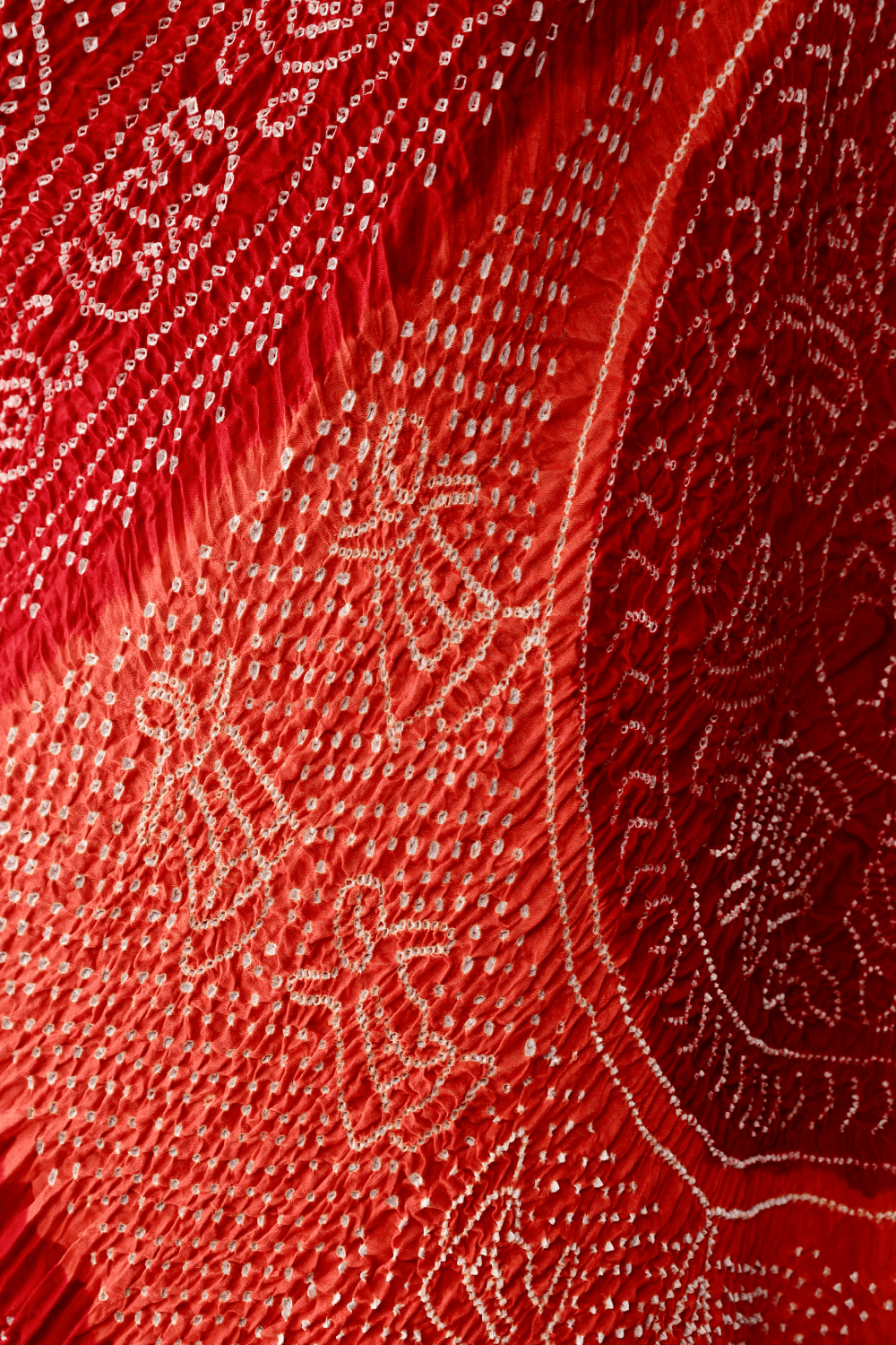 Handcrafted tomato red and orange Rai Bandhej dupatta made from premium Gajji silk