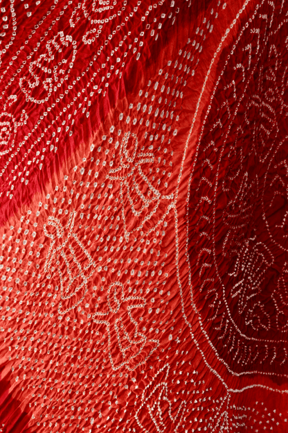 Handcrafted tomato red and orange Rai Bandhej dupatta made from premium Gajji silk