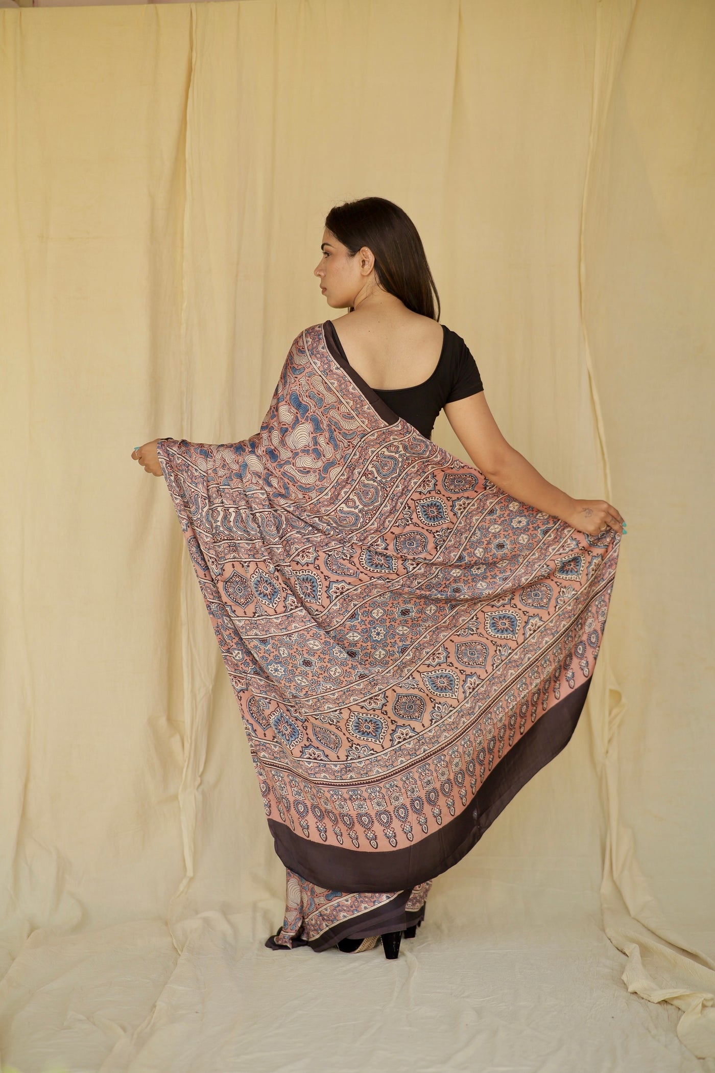 Premium antique rose modal silk saree with heritage-inspired Ajrakh designs and fluid texture