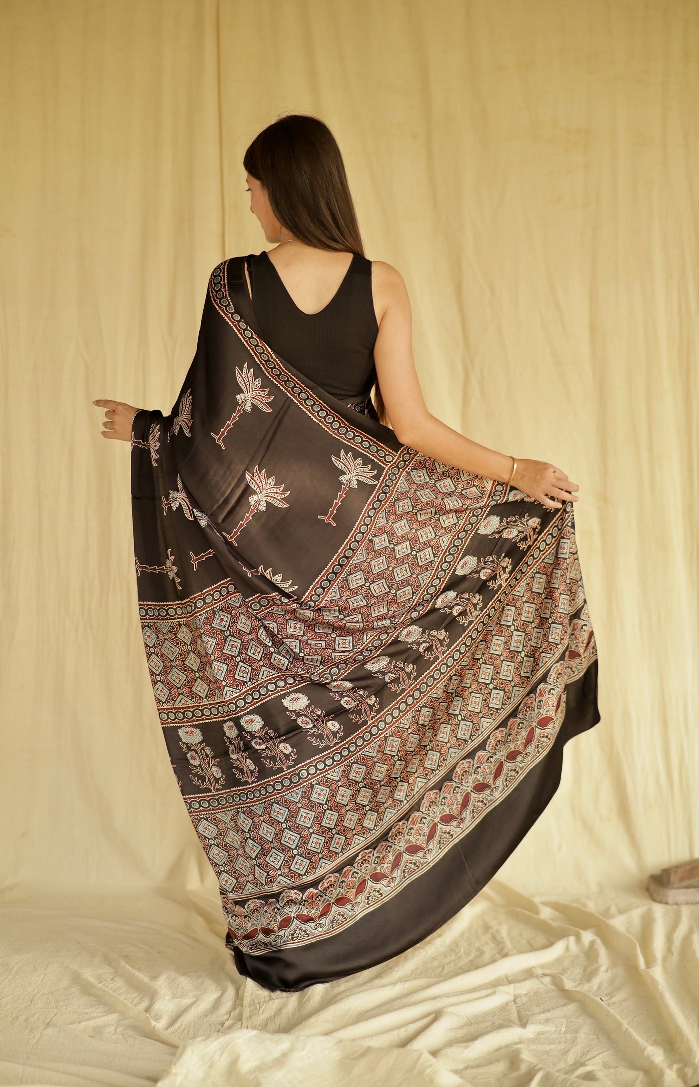 Premium black Ajrakh modal silk saree with lotus-inspired motifs and heritage craftsmanship