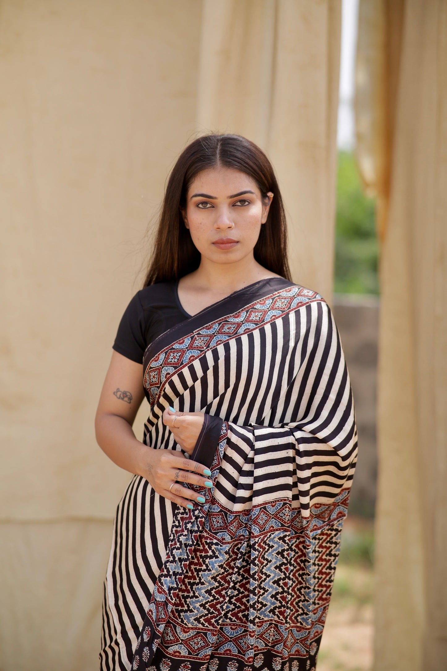 Premium black and white striped modal silk saree with heritage-inspired Ajrakh designs and fluid texture