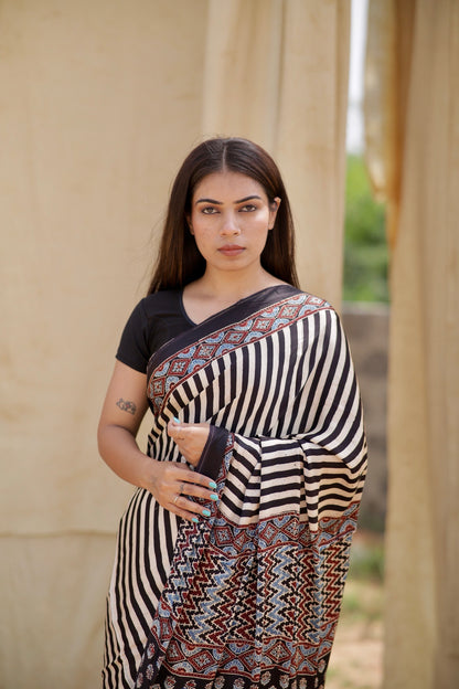Premium black and white striped modal silk saree with heritage-inspired Ajrakh designs and fluid texture