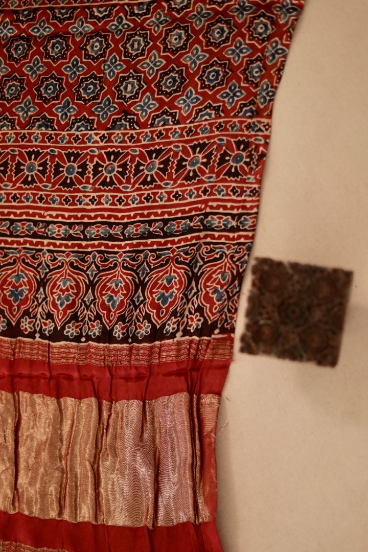 Traditional burnt rust Ajrakh modal silk dupatta showcasing authentic artisan craftsmanship and decorative borders